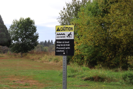 Sign – caution ahead – water/mud may be on trail – proceed with caution